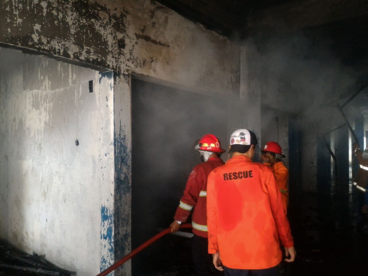 Petugas BPBD tengah memadamkan api yang membakar lantai 2 Pasar Tugu, Jumat (3/2), (Foto: Lampungnews.com/Adam)