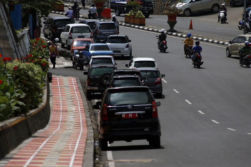 Sejumlah kendaraan parkir hingga ke badan Jalan Dr. Susilo dan kerap kali membuat kemacetan. (Lampungnews/El Shinta)