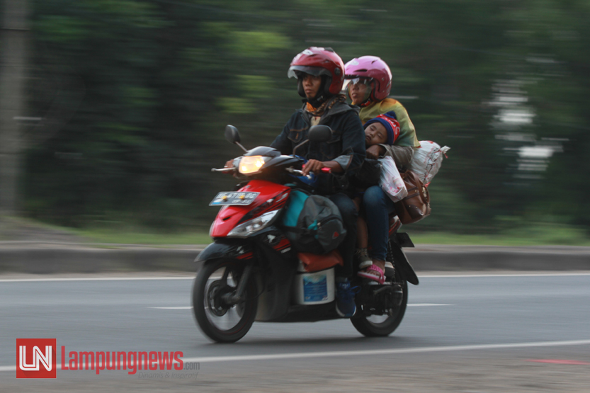 Sejumlah pemudik dari Pulau Jawa yang menggunakan sepeda motor mulai memasuki Jalan Lintas Sumatera, Jumat (23/6). Para pemudik sepeda motor ini kerap kali membahayakan diri sendiri dengan berboncengan lebih dari satu orang dan membawa beban yang cukup berat. (Lampungnews/El Shinta)